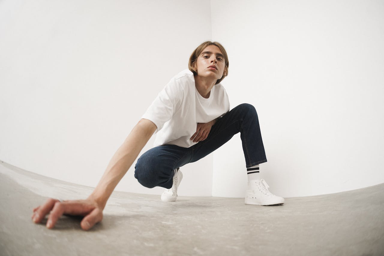 A Man Wearing White Shirt and Denim Jeans